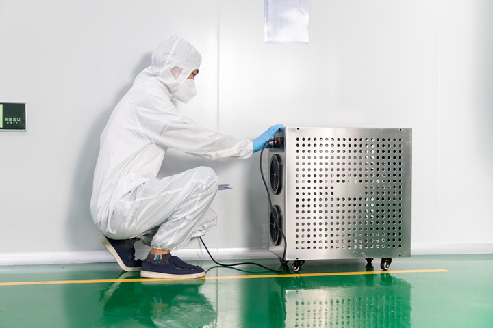 A staff member disinfects our cleanroom.