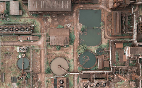 Aged industrial area with dirty roofs and ponds