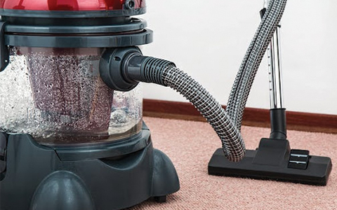 Black and Red Canister Vacuum Cleaner on Floor