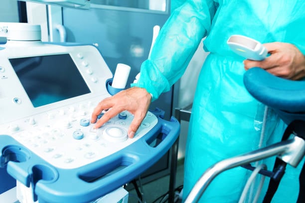 Gynecologist prepares for surgery in operating room, Ultrasound medical device